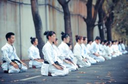 group of martial artists sitting on the grounds
