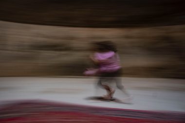 girl in pink shirt and pink pants running on track field